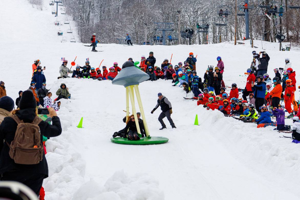 3 employees riding chairlift