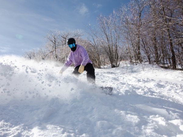 Snowboarder turning in powder snow.