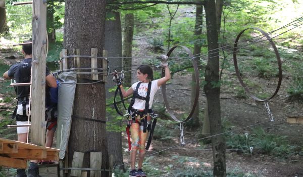 A young girl getting ready to climb on the aerial adventure park at Catamount Resort