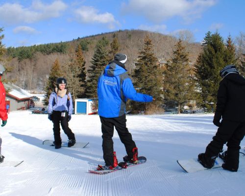 Snowboard instructor giving lessons at Catamount Resort