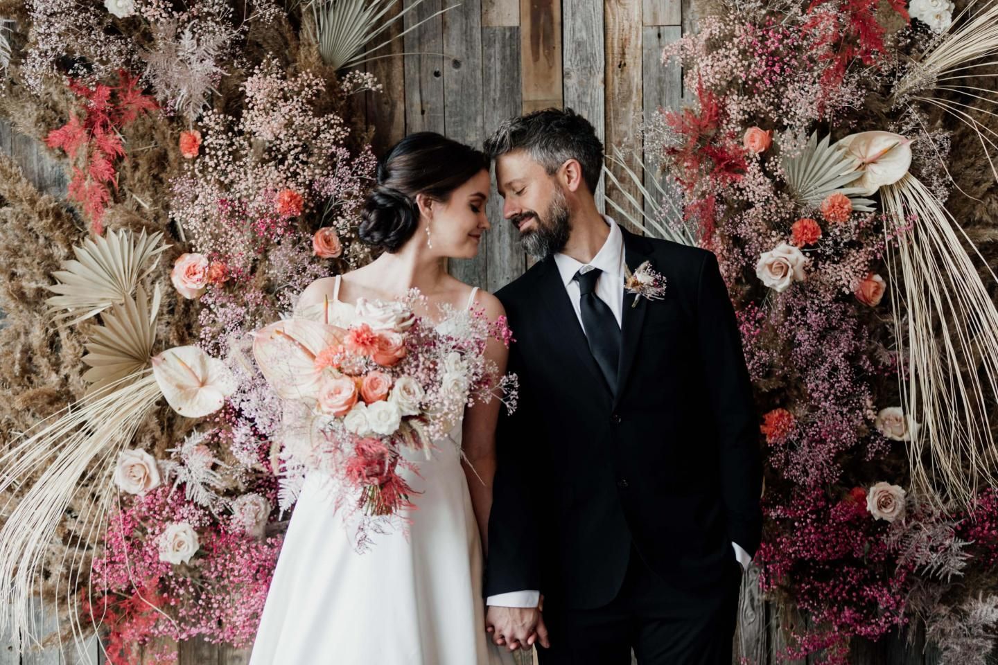 A couple touching foreheads and smiling after getting married at Catamount Resort