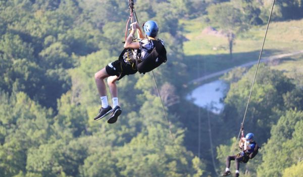 Two teenaged boys on the zipline at Catamount Resort