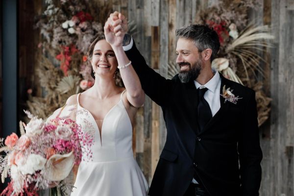 A happy couple holding hands after getting married at Catamount Resort