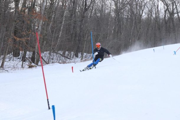 A ski racer skiing through a slalom course at Catamount Ski Resort