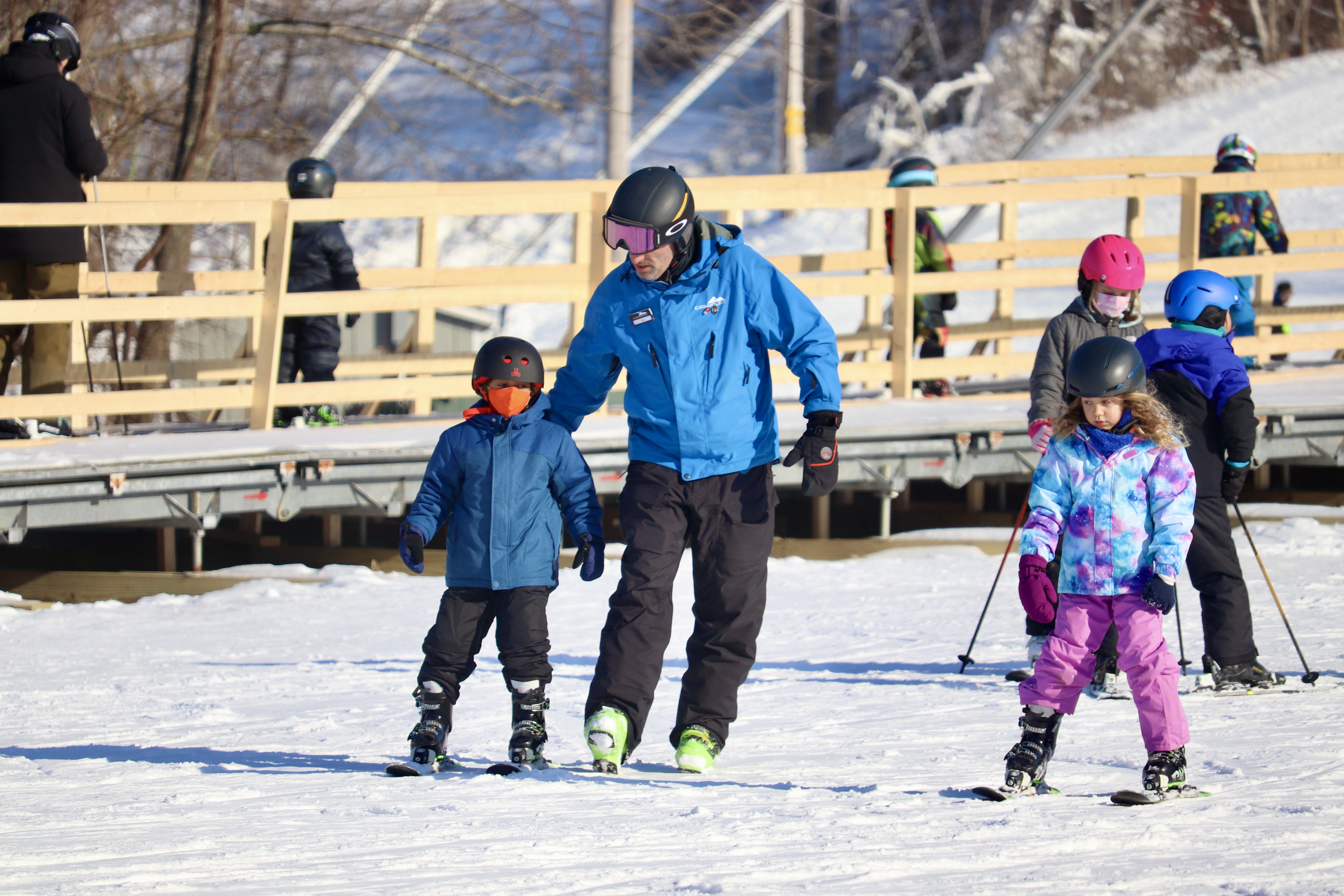 Catamount Snow Sports Instructor guiding child down the learning slope