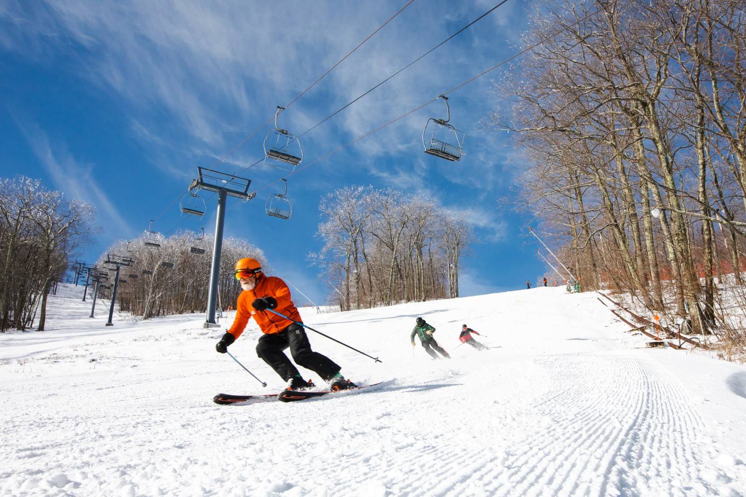 Man skiing down trail at Catamount