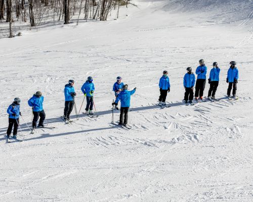 A lone snowboard instructor carving a turn on freshly groomed snow at Catamount Ski Resort