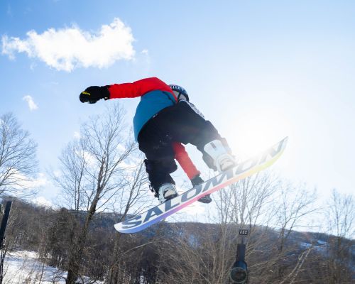 A young snowboarder taking a jump at Catamount Ski Resort