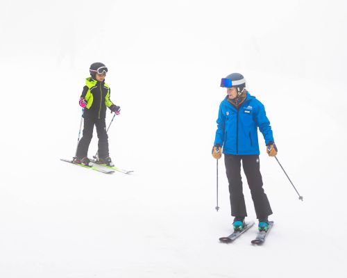A large group of kids smiling with their ski instructors at Catamount Ski Resort