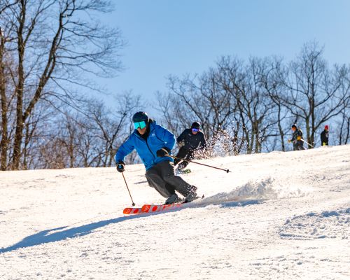 Snowboard instructor giving lessons at Catamount Resort