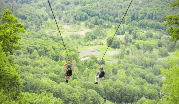 Two zipliners at Catamount Mountain Resort