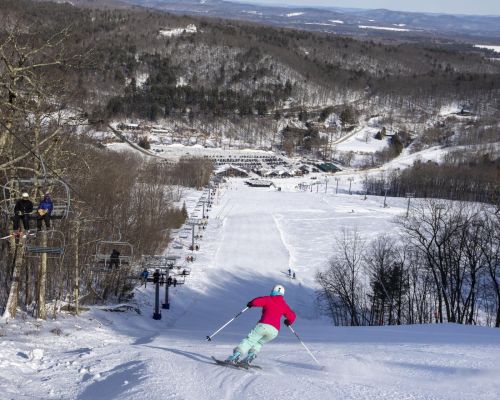 Femail Skier carving down the mountain