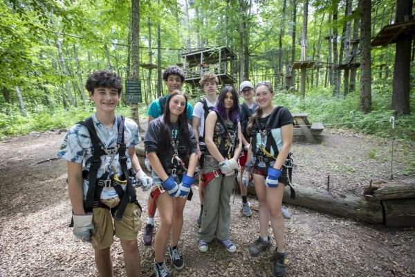 A school group smiling at the Aerial Adventure Park. Click here for Summer Group Activities.