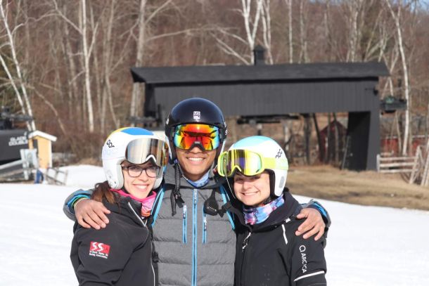 A ski coach posing with two junior ski racers at Catamount Ski Resort