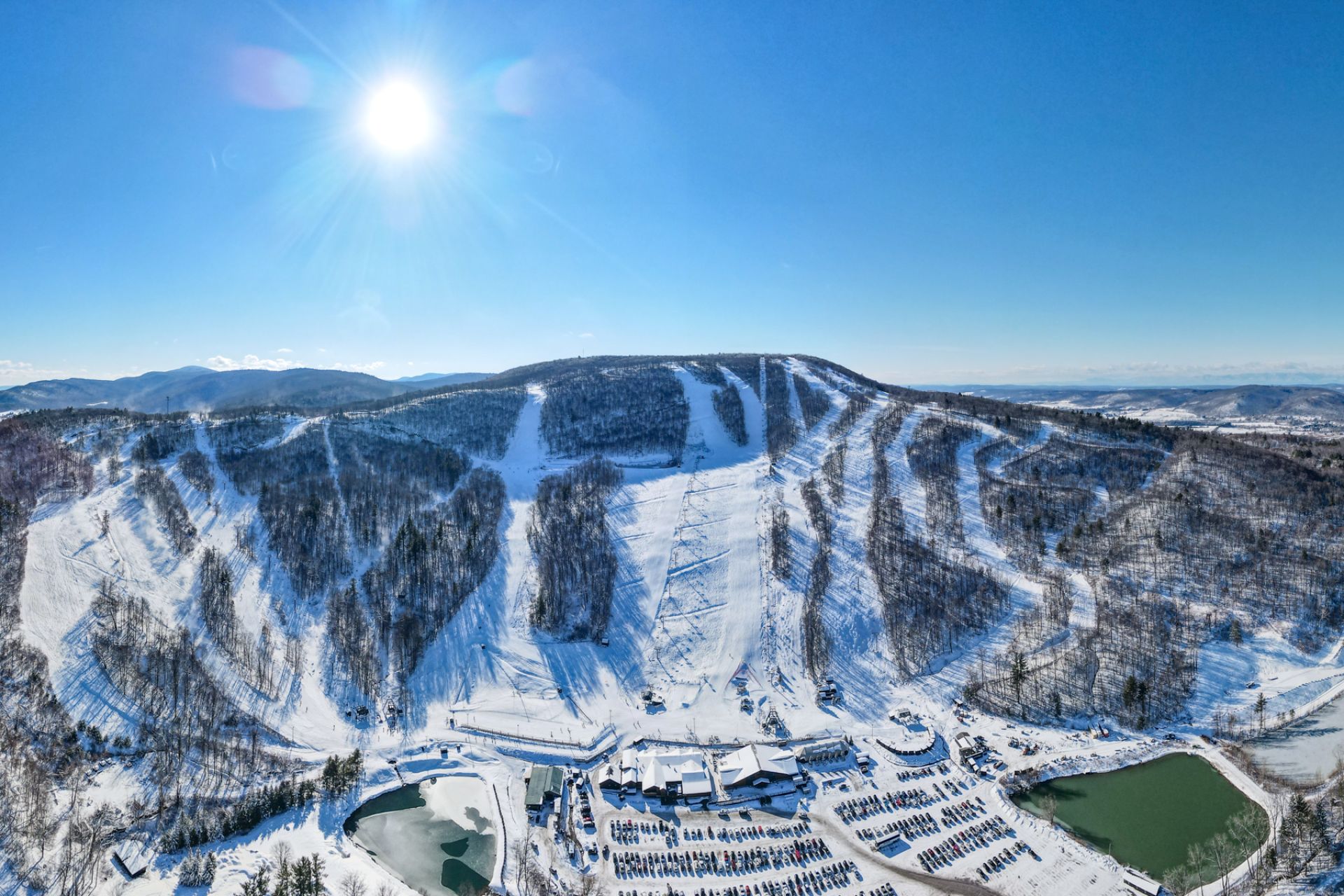 An aerial shot of the mountain in the winter.